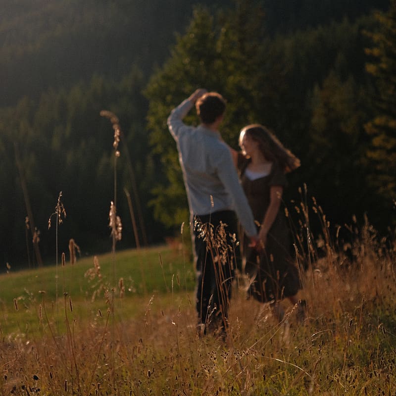 Lily & Elijah standing in a field.