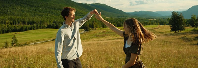 A scenic view of a lake surrounded by mountains and trees